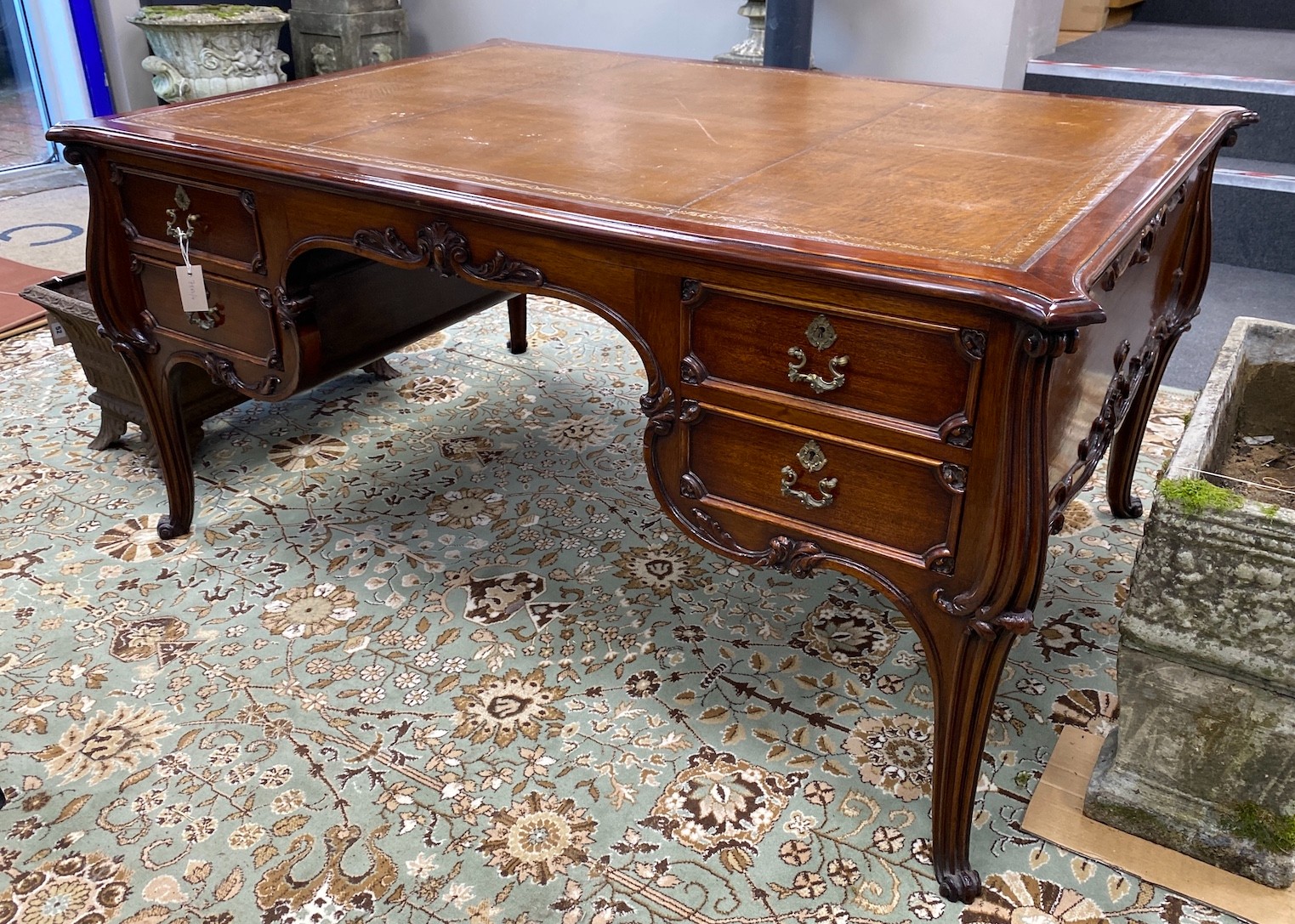 An early 20th century mahogany kneehole partner's desk with tooled tan leather inset top, length 154cm, depth 110cm, height 73cm